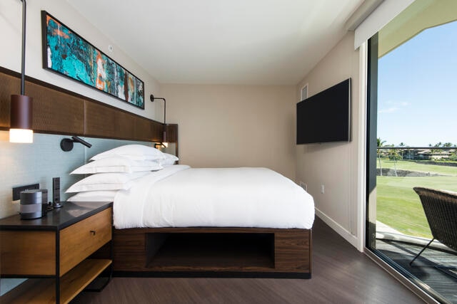 Master bedroom with view of the golf course at Ocean Tower by Hilton Grand Vacations on The Big Island of Hawaii. 