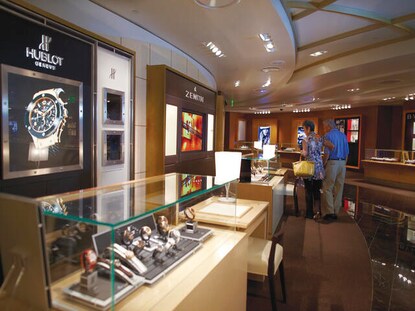 Interior shot of retail store while tourists shop for souvenirs. 