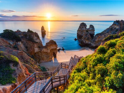 Picturesque wooden boardwalk leading to the beach in Portugal. 