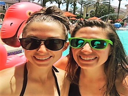 Hilton Grand Vacations Owner and sister snapping poolside vacation selfie. 