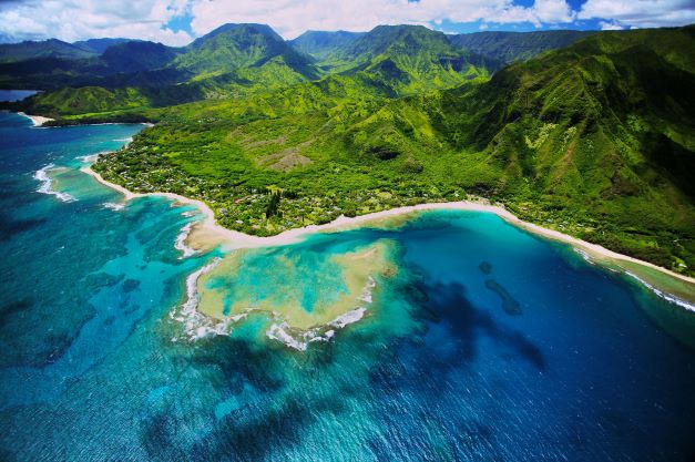 Stunning aerial image, emerald cliffs, turquoise water, Kauai, Hawaii. 