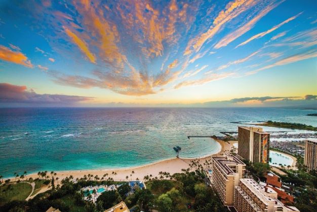 Stunning aerial image of Oahu shoreline, sunset painted skies overhead, Hawaii. 