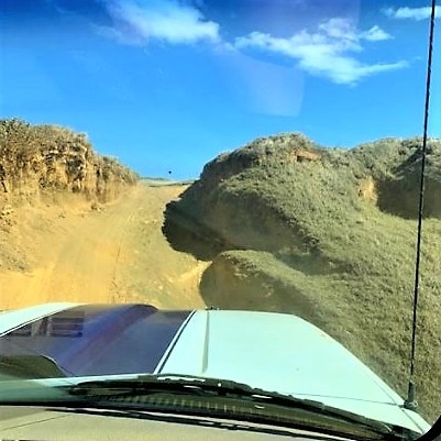 Point of view image of rugged road leading to Papakolea Green Sand Beach, Big Island, Hawaii. 